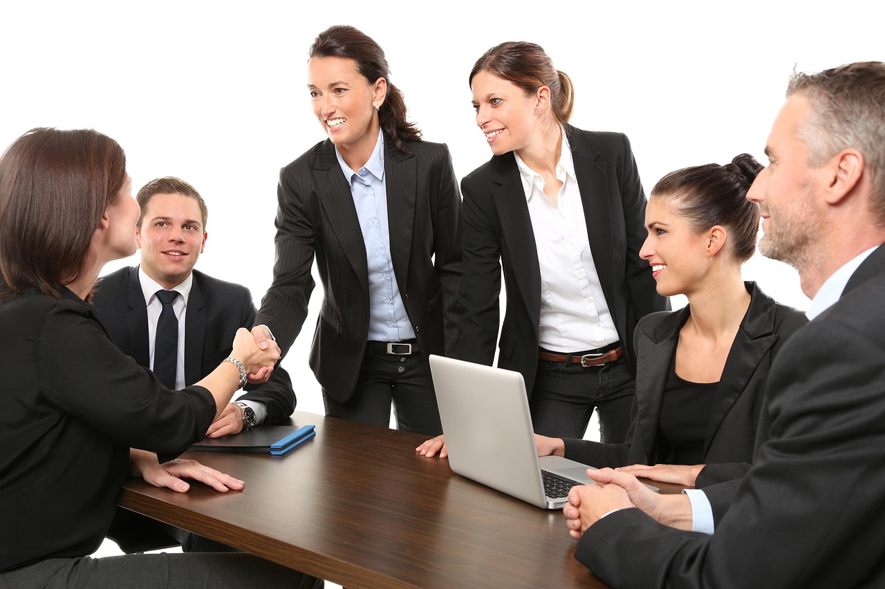 Team members reviewing interface notes on a large display in a bright workspace